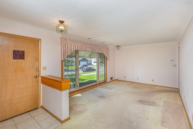 2165 Ross Ave E, Saint Paul, MN 55119 - carpeted foyer entrance featuring a textured ceiling and baseboards