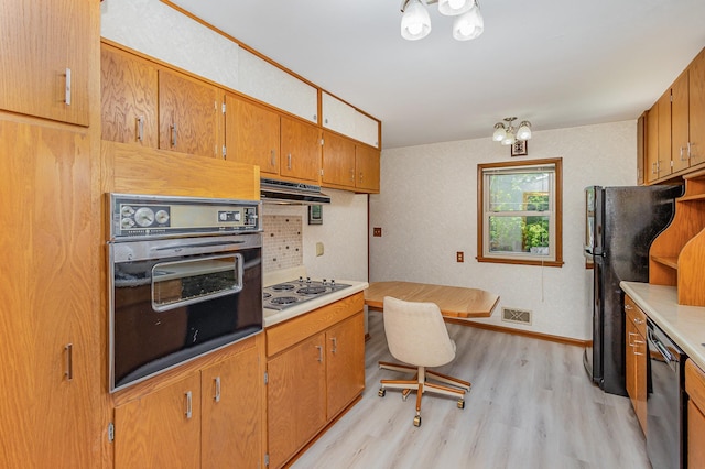 2165 Ross Ave E, Saint Paul, MN 55119 - kitchen featuring black appliances, light wood-style flooring, light countertops, baseboards, and brown cabinets