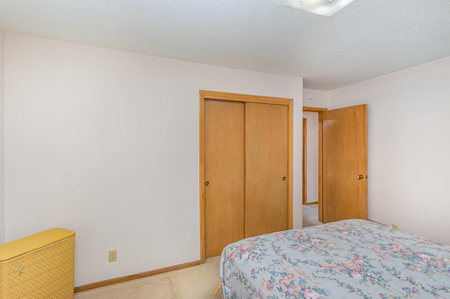 2165 Ross Ave E, Saint Paul, MN 55119 - bedroom featuring light carpet, a closet, and baseboards