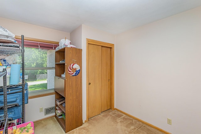 2165 Ross Ave E, Saint Paul, MN 55119 - unfurnished bedroom with light colored carpet, baseboards, and a closet