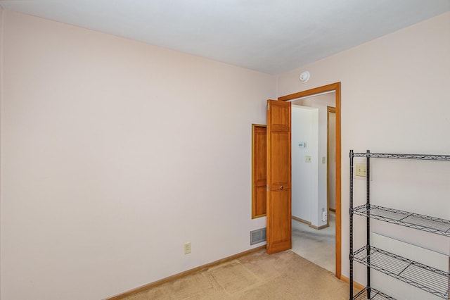 2165 Ross Ave E, Saint Paul, MN 55119 - empty room with light colored carpet, baseboards, and a smoke detector