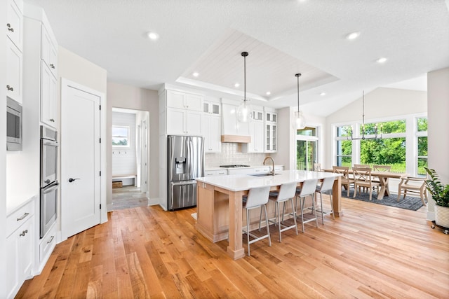 2995 86th St SE, Delano, MN 55328 - kitchen featuring stainless steel appliances, a center island with sink, healthy amount of natural light, backsplash, and recessed lighting