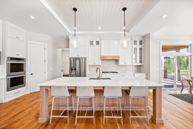2995 86th St SE, Delano, MN 55328 - kitchen with stainless steel appliances, a tray ceiling, light wood-type flooring, wooden ceiling, and recessed lighting