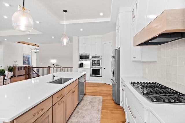 2995 86th St SE, Delano, MN 55328 - kitchen featuring premium range hood, appliances with stainless steel finishes, light wood-style floors, recessed lighting, and tasteful backsplash