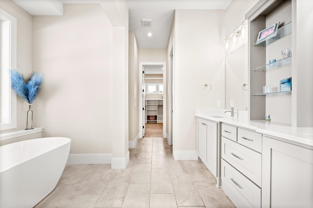 2995 86th St SE, Delano, MN 55328 - full bath featuring vanity, a freestanding bath, recessed lighting, and marble look tiles