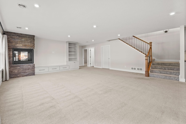 2995 86th St SE, Delano, MN 55328 - unfurnished living room featuring light colored carpet, stairs, a fireplace, and recessed lighting