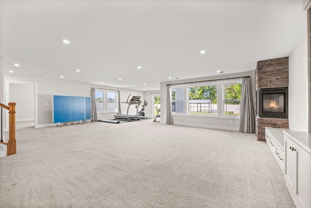 2995 86th St SE, Delano, MN 55328 - exercise room featuring light carpet, recessed lighting, and a stone fireplace