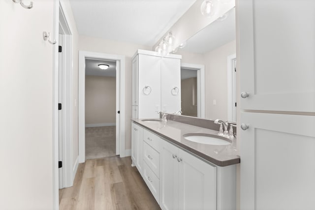 2995 86th St SE, Delano, MN 55328 - bathroom with double vanity and wood finished floors