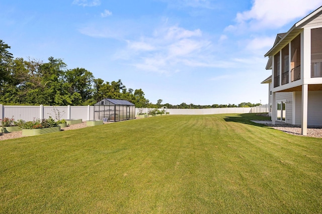 2995 86th St SE, Delano, MN 55328 - fenced backyard featuring an exterior structure, a vegetable garden, and an outbuilding