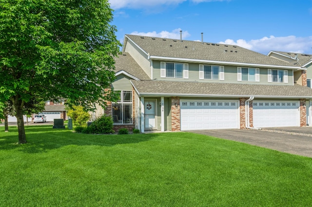 14754 Peridot St NW, Ramsey, MN 55303 - view of front of property featuring asphalt driveway, a front yard, roof with shingles, brick siding, and a garage