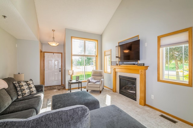 14754 Peridot St NW, Ramsey, MN 55303 - living room with carpet, a glass covered fireplace, baseboards, and high vaulted ceiling