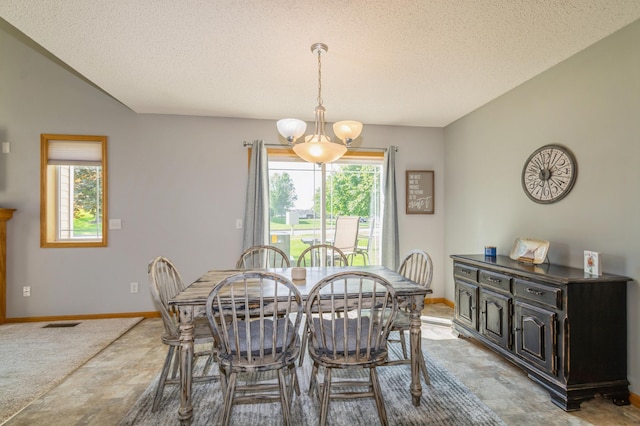 14754 Peridot St NW, Ramsey, MN 55303 - dining room with a chandelier, stone finish floors, baseboards, and a textured ceiling