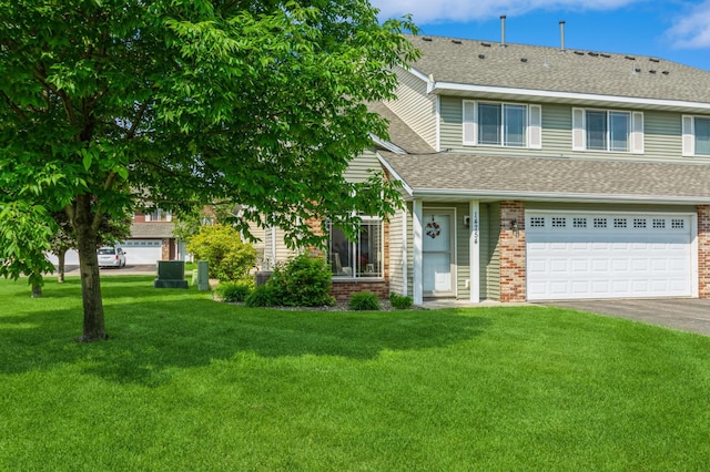 14754 Peridot St NW, Ramsey, MN 55303 - view of front facade featuring brick siding, asphalt driveway, a front yard, and an attached garage