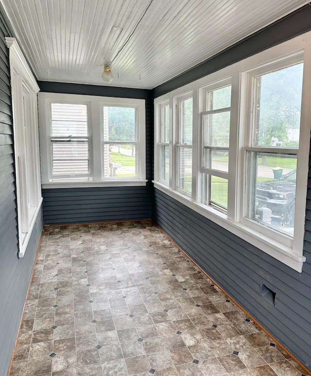 803 Jefferson Ave, Albert Lea, MN 56007 - unfurnished sunroom featuring wood walls