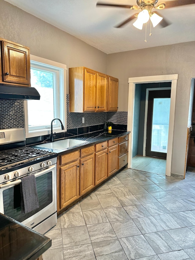 803 Jefferson Ave, Albert Lea, MN 56007 - kitchen with stainless steel range with gas stovetop, range hood, a sink, tasteful backsplash, and ceiling fan