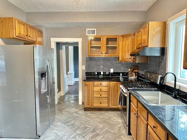 803 Jefferson Ave, Albert Lea, MN 56007 - kitchen with stainless steel appliances, a sink, range hood, tasteful backsplash, and glass insert cabinets