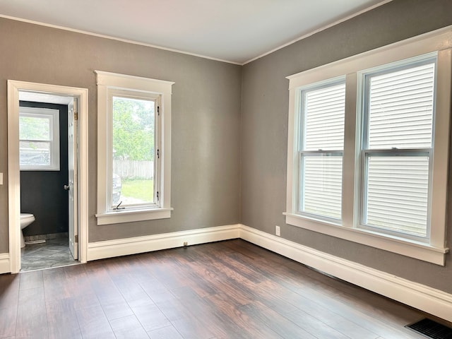803 Jefferson Ave, Albert Lea, MN 56007 - spare room with ornamental molding, dark wood-type flooring, and baseboards