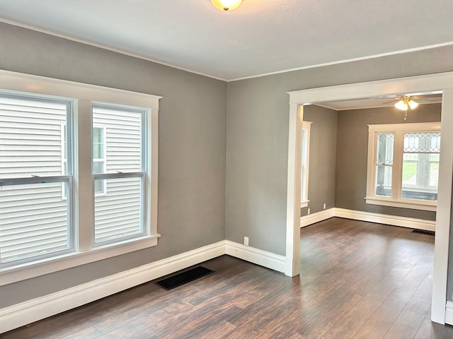 803 Jefferson Ave, Albert Lea, MN 56007 - unfurnished room with dark wood finished floors, baseboards, a ceiling fan, and ornamental molding