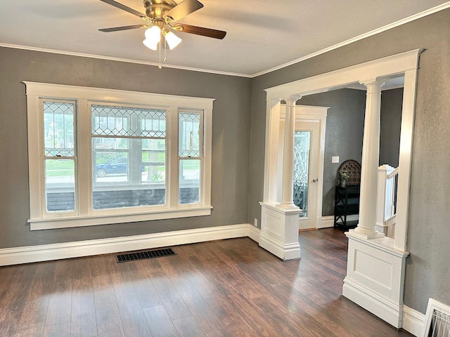 803 Jefferson Ave, Albert Lea, MN 56007 - unfurnished room with decorative columns, dark wood-style floors, ceiling fan, baseboards, and ornamental molding