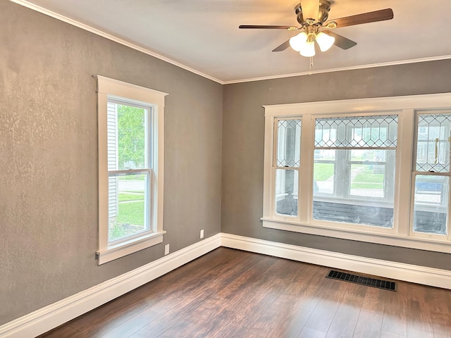 803 Jefferson Ave, Albert Lea, MN 56007 - empty room featuring dark wood-style floors, ornamental molding, ceiling fan, baseboards, and a textured wall