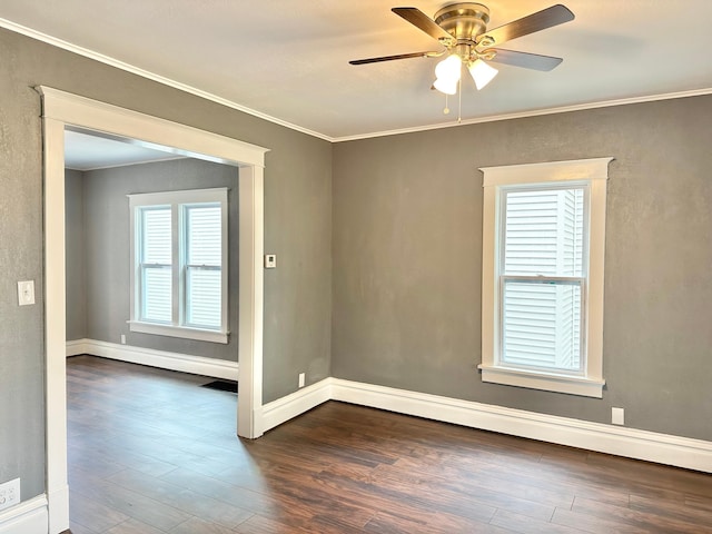 803 Jefferson Ave, Albert Lea, MN 56007 - spare room featuring dark wood-type flooring, a ceiling fan, crown molding, and baseboards