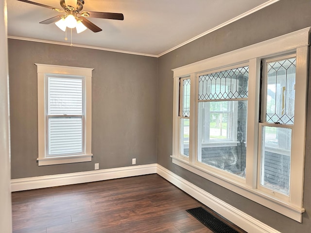 803 Jefferson Ave, Albert Lea, MN 56007 - empty room with dark wood-type flooring, baseboards, crown molding, and a ceiling fan