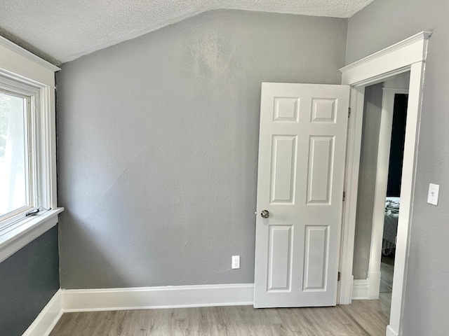 803 Jefferson Ave, Albert Lea, MN 56007 - unfurnished room featuring light wood-type flooring, a textured ceiling, and baseboards