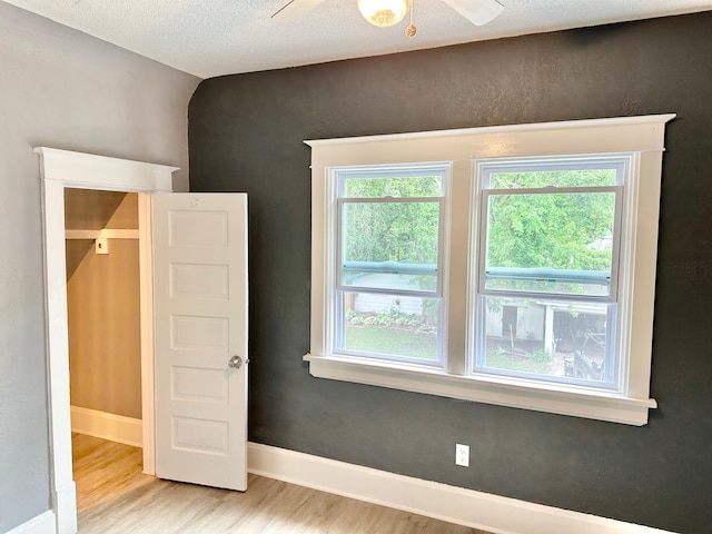 803 Jefferson Ave, Albert Lea, MN 56007 - unfurnished room featuring light wood-type flooring, ceiling fan, and baseboards