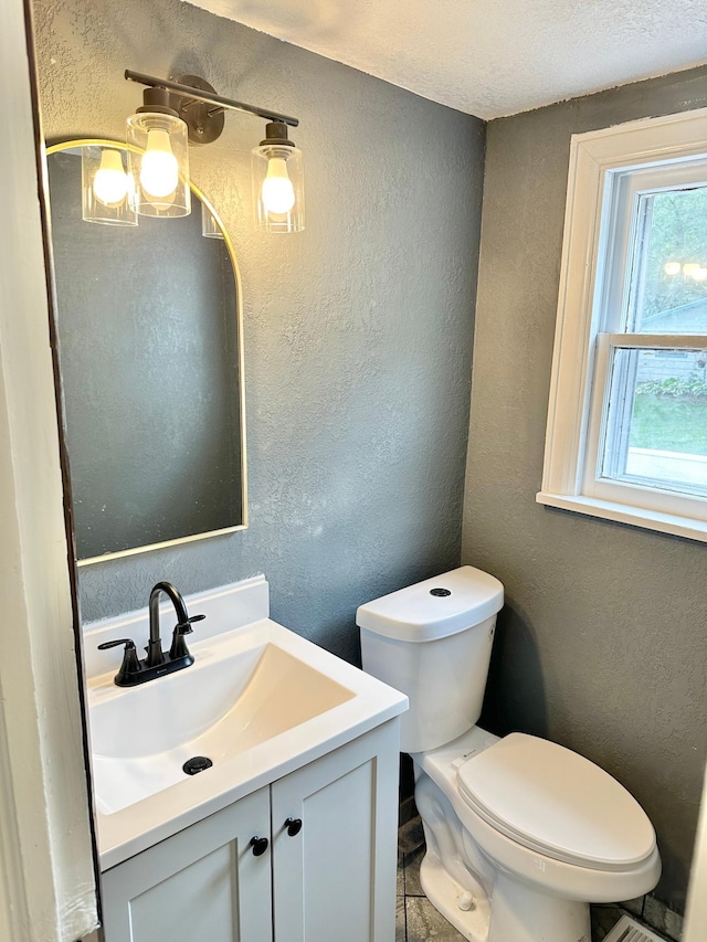 803 Jefferson Ave, Albert Lea, MN 56007 - half bath with a textured wall, vanity, and a textured ceiling