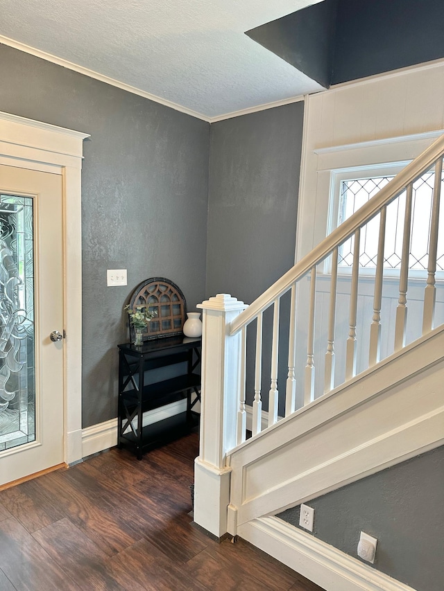 803 Jefferson Ave, Albert Lea, MN 56007 - staircase featuring wood finished floors, ornamental molding, a textured wall, and a textured ceiling