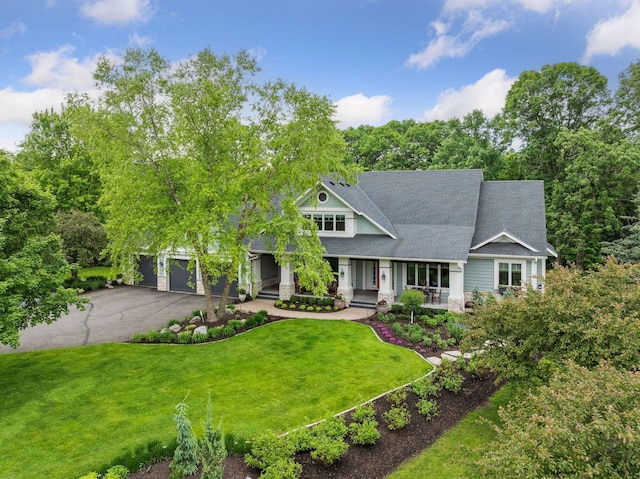 10025 Adam Ave, Inver Grove Heights, MN 55077 - view of front facade with driveway, covered porch, a front lawn, and roof with shingles