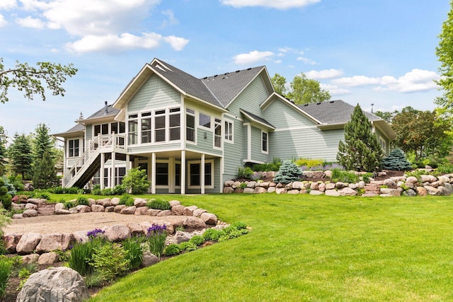 10025 Adam Ave, Inver Grove Heights, MN 55077 - back of property featuring a sunroom, stairs, a lawn, a shingled roof, and a deck