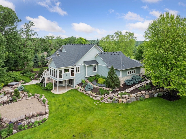 10025 Adam Ave, Inver Grove Heights, MN 55077 - back of property with a patio area, roof with shingles, a yard, a sunroom, and a wooden deck
