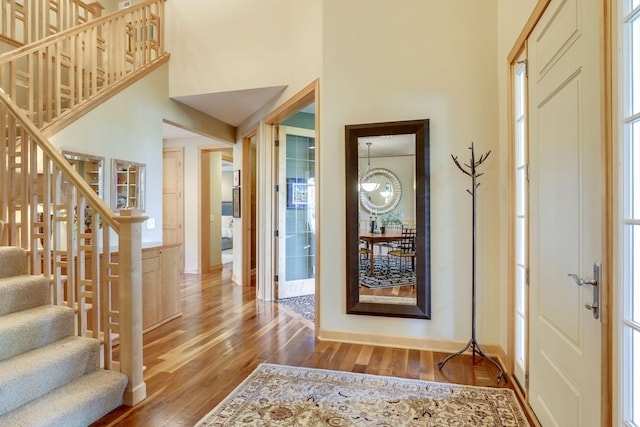 10025 Adam Ave, Inver Grove Heights, MN 55077 - entrance foyer with hardwood / wood-style floors, stairs, a towering ceiling, and plenty of natural light