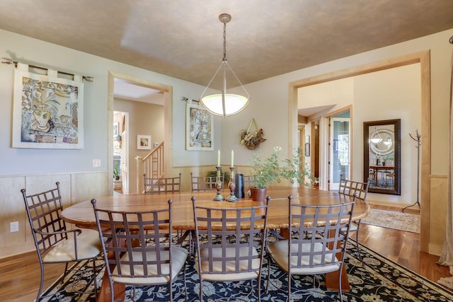 10025 Adam Ave, Inver Grove Heights, MN 55077 - dining room with wood finished floors, plenty of natural light, and stairway