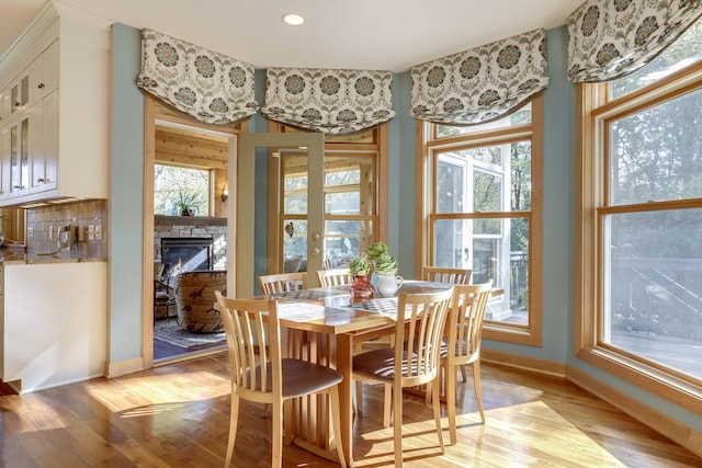 10025 Adam Ave, Inver Grove Heights, MN 55077 - dining space featuring light wood-type flooring and a stone fireplace