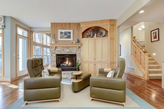 10025 Adam Ave, Inver Grove Heights, MN 55077 - living area with wood finished floors, stairs, a fireplace, and recessed lighting