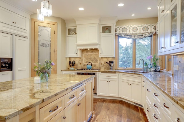 10025 Adam Ave, Inver Grove Heights, MN 55077 - kitchen with wood finished floors, recessed lighting, tasteful backsplash, light stone counters, and white cabinetry