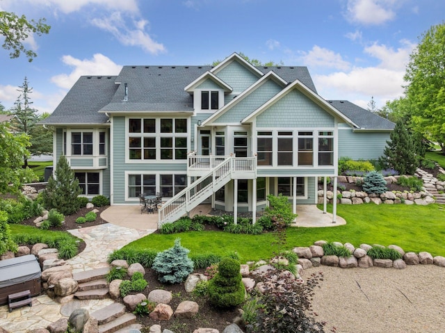 10025 Adam Ave, Inver Grove Heights, MN 55077 - rear view of property featuring a sunroom, a patio, stairs, and a lawn