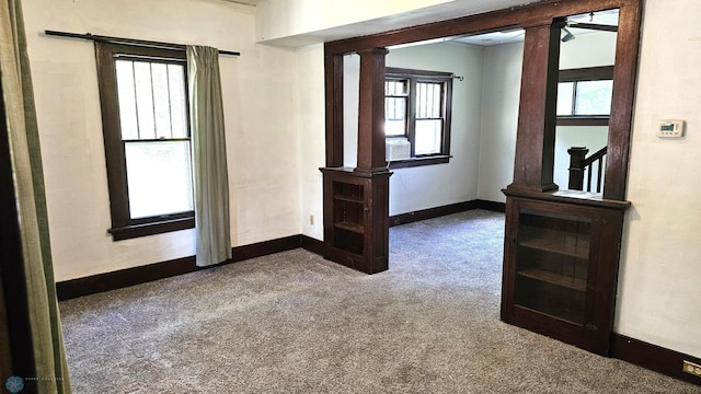 1602 11th St N, Fargo, ND 58102 - carpeted empty room with ornate columns, plenty of natural light, and baseboards