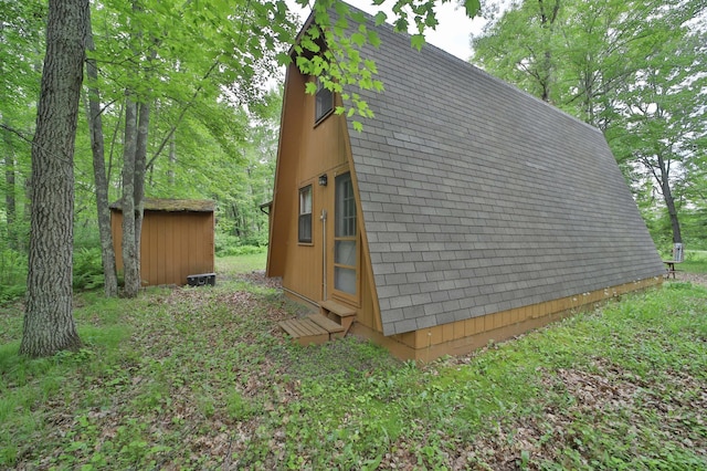 19489 Blue Ln E, Emily, MN 56447 - view of side of home featuring an outbuilding and entry steps