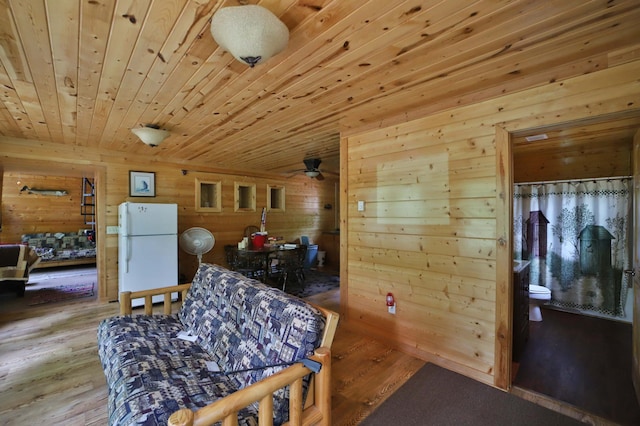 19489 Blue Ln E, Emily, MN 56447 - sitting room with wood walls, wood ceiling, light wood-style flooring, and ceiling fan
