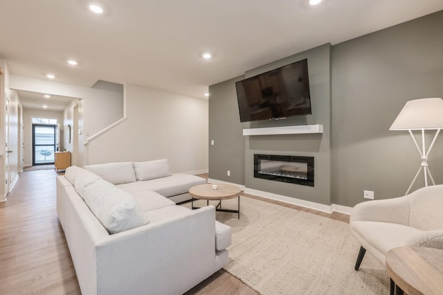 19236 Grass Lake Trl, Rogers, MN 55374 - living area featuring wood finished floors, baseboards, recessed lighting, and a glass covered fireplace