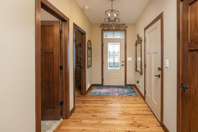 2238 Marvs Ln NE, Stewartville, MN 55976 - doorway featuring light wood-style flooring, a chandelier, and baseboards