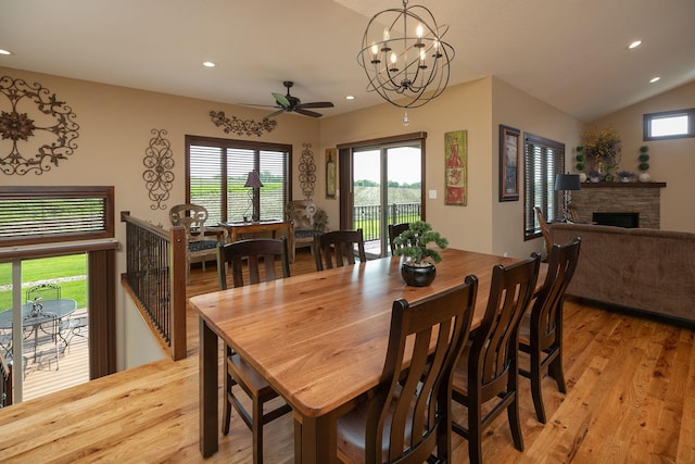 2238 Marvs Ln NE, Stewartville, MN 55976 - dining area with a stone fireplace, light wood finished floors, recessed lighting, ceiling fan, and vaulted ceiling