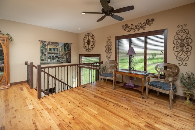2238 Marvs Ln NE, Stewartville, MN 55976 - sitting room featuring wood finished floors, ceiling fan, an upstairs landing, and baseboards