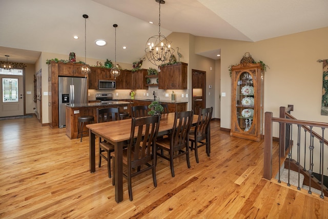 2238 Marvs Ln NE, Stewartville, MN 55976 - dining room with a chandelier, light wood-style floors, recessed lighting, stairway, and high vaulted ceiling