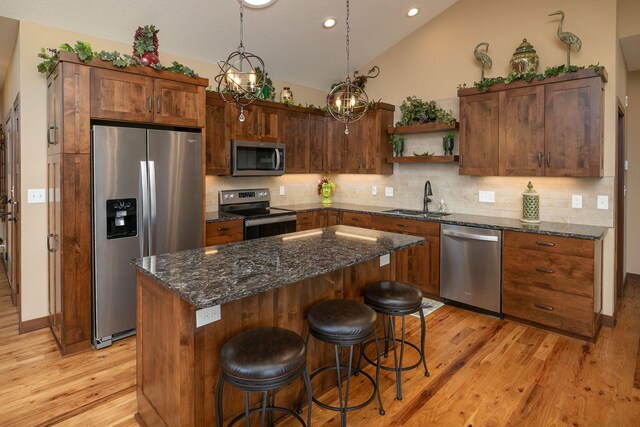 2238 Marvs Ln NE, Stewartville, MN 55976 - kitchen featuring appliances with stainless steel finishes, a sink, light wood-style floors, decorative backsplash, and lofted ceiling