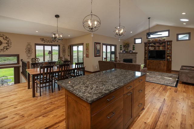 2238 Marvs Ln NE, Stewartville, MN 55976 - kitchen with light wood-style floors, a stone fireplace, vaulted ceiling, decorative light fixtures, and a ceiling fan