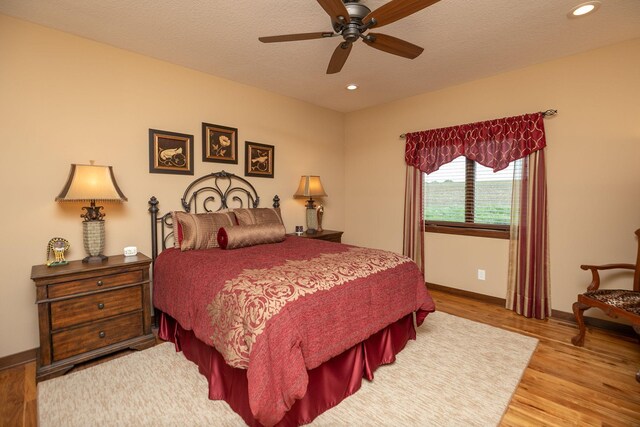 2238 Marvs Ln NE, Stewartville, MN 55976 - bedroom with wood finished floors, baseboards, recessed lighting, a textured ceiling, and a ceiling fan